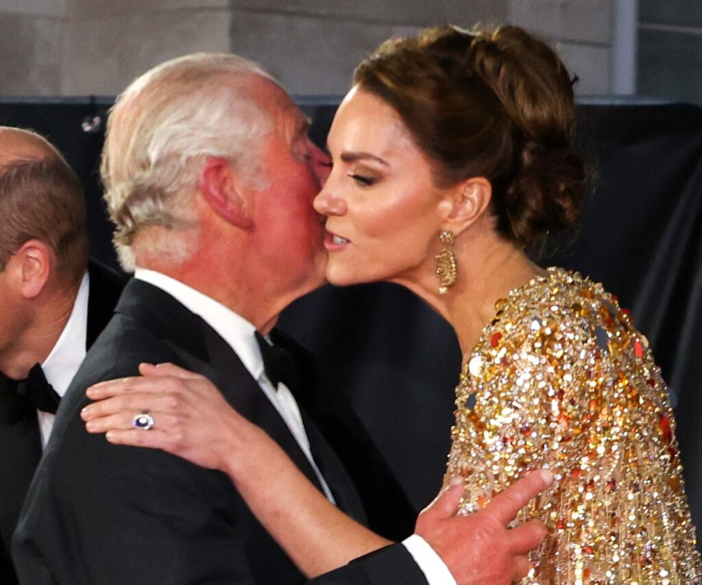 King Charles kissing Princess Catherine on the cheek.