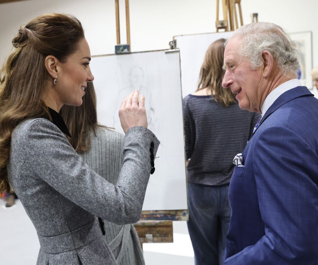 Kate Middleton and King Charles smiling and talking to each other.