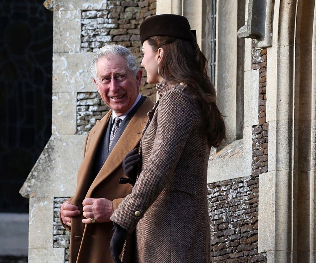 King Charles and Kate Middleton smiling together.