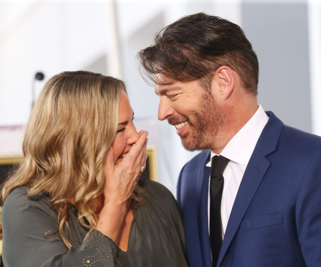 Harry Connick Jr and wife Jill Goodacre smiling and laughing together.