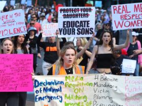 Australians protest domestic violence, carrying signs Real Men Respect Women, etc