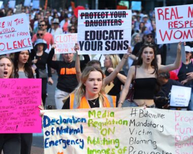 Australians protest domestic violence, carrying signs Real Men Respect Women, etc