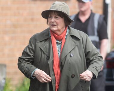 Brenda Blethyn as Vera, wearing red scarf, hat and coat