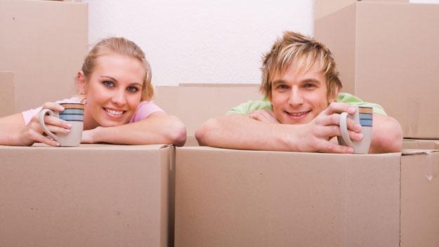young couple with cardboard boxes, thinkstock