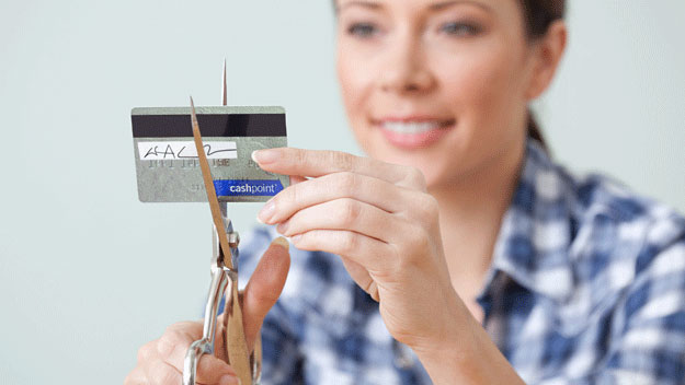 woman cutting up her credit card, Getty Images