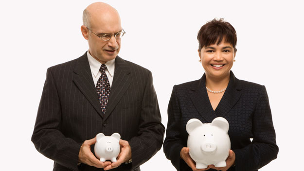 man and woman golding piggy banks, thinkstock