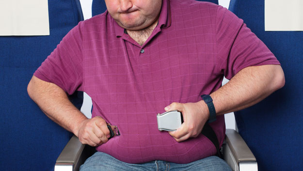 Fat man in airplane seat