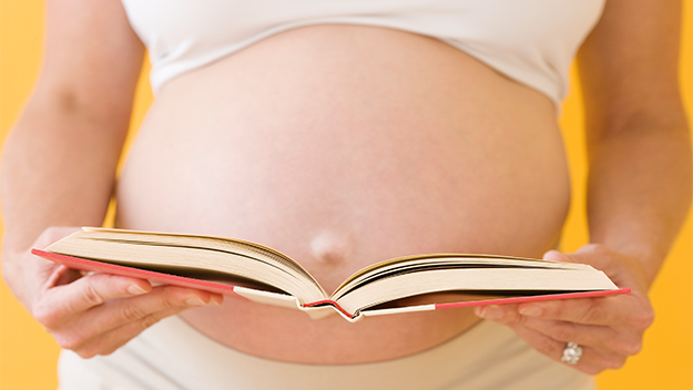 Pregnant women reading a book