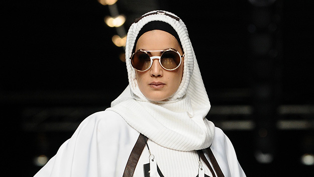 Model wearing hijab showcases designs by Hannie Hananto on the runway during Jakarta Fashion Week 2014.