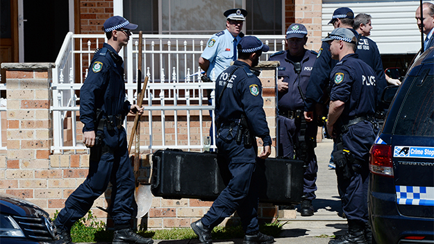 NSW Police and Australian Federal Police during a raid on a house in Guildford, Sydney.