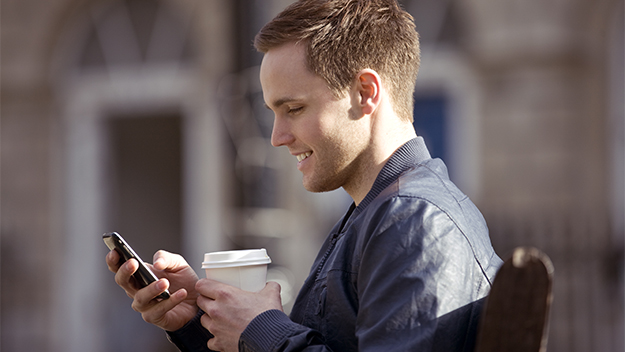 man on mobile phone with coffee, stock image