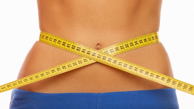 Woman's waist with measuring tape, diet, stock image