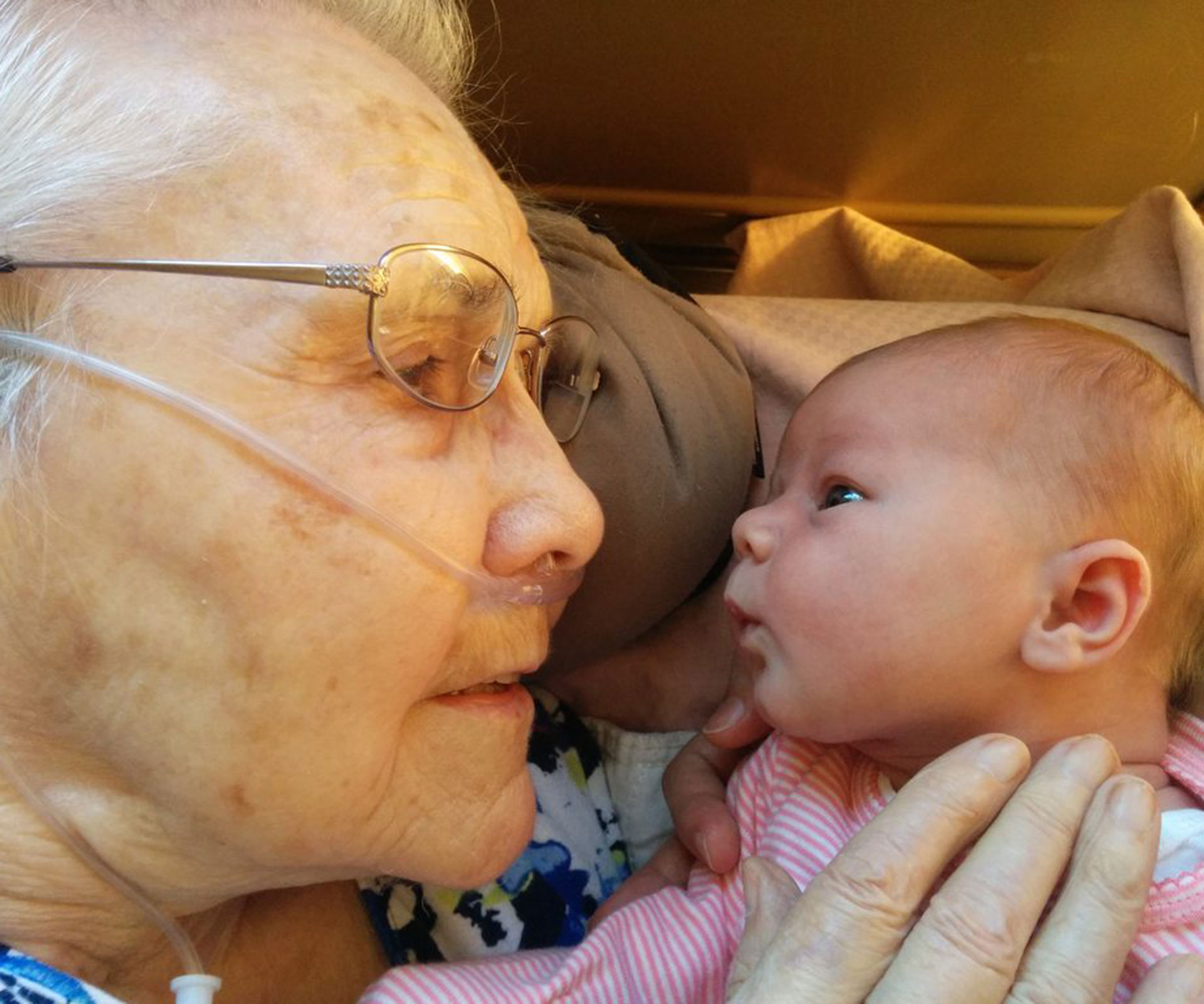 Newborn meets great-grandmother for first time