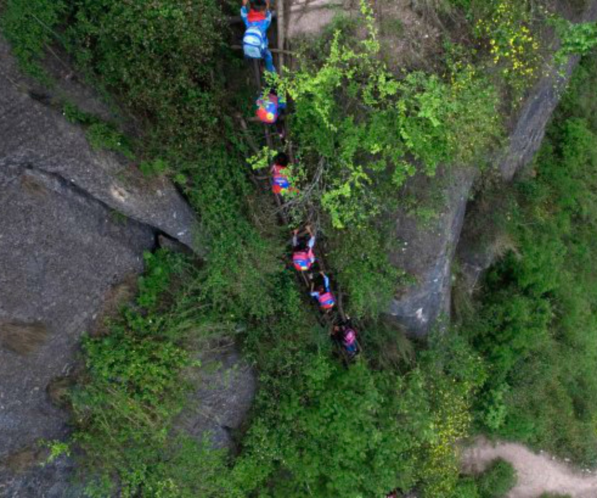 Children climb 800m cliff to get to and from school