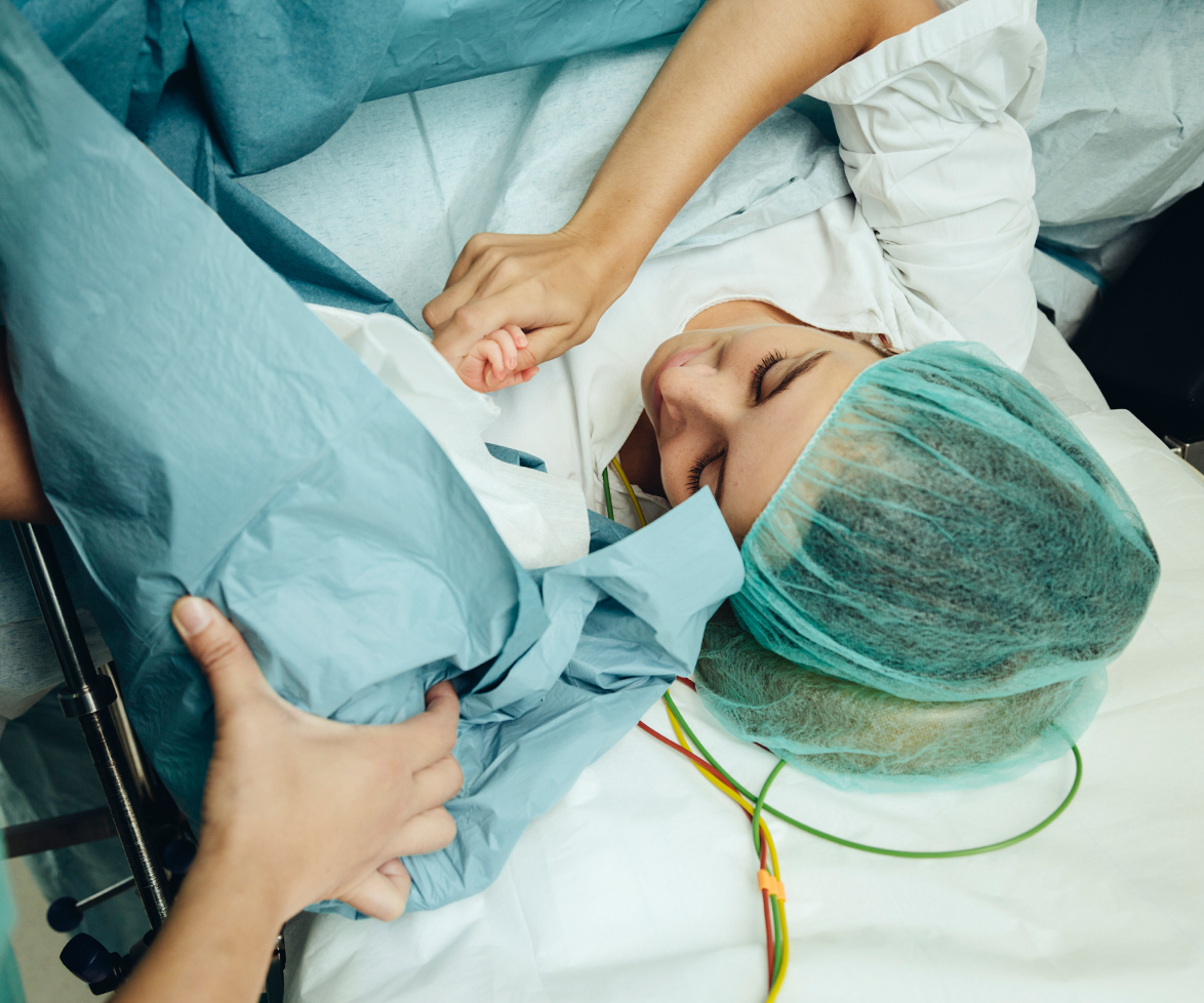 Woman giving birth via c-section