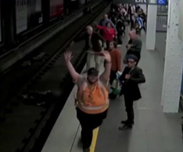 Terrifying footage of man lurching in front of oncoming train