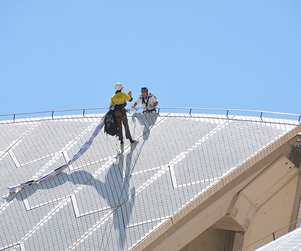 Activists scale the iconic Sydney Opera House in protest of the Manus Island humanitarian crisis