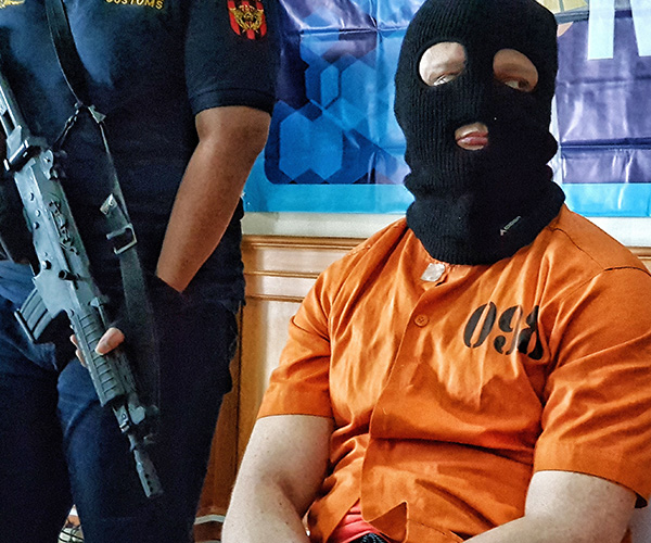 Why was Australia’s latest accused drug smuggler forced to wear a balaclava and jumpsuit?