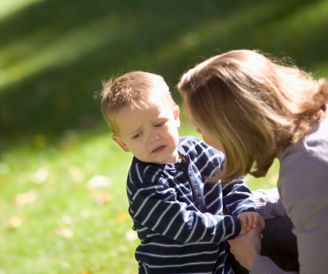 Mother trying to get toddler to listen at park