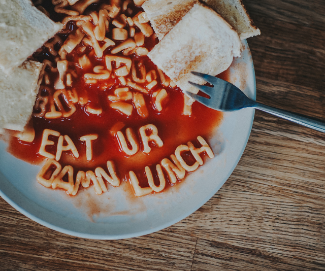 Plate of spaghetti alphabet spelling out eat Your Damn Lunch