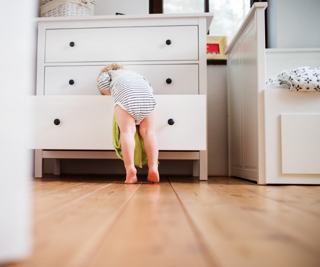 child friendly furniture - small child climbing into drawer
