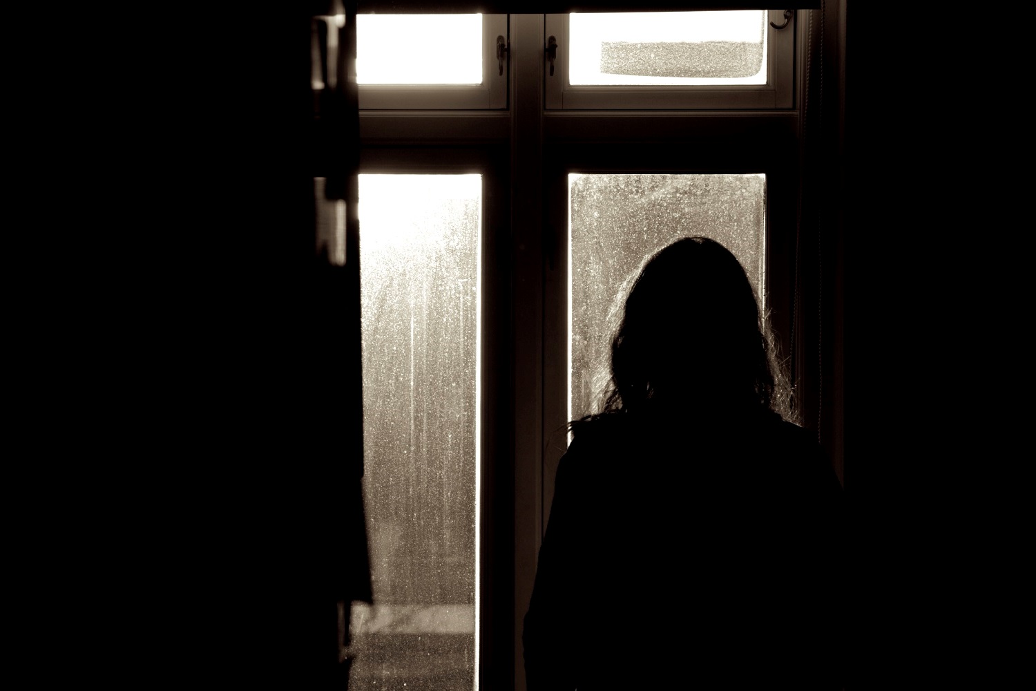 Woman standing in front of window