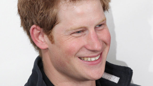 Prince Harry dives into pool fully clothed