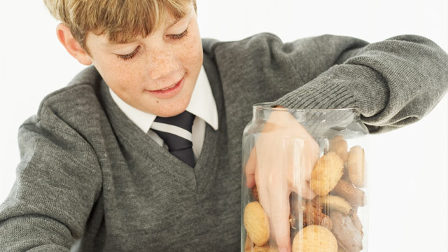 School boy eating biscuits