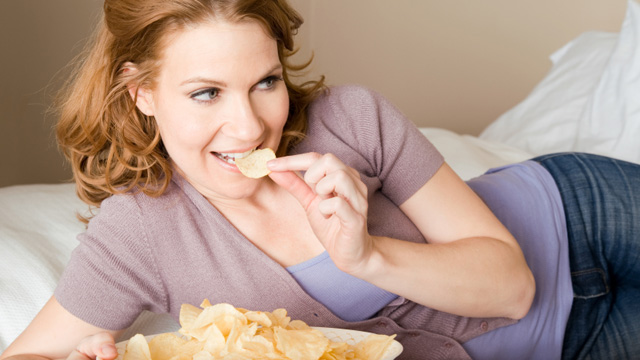 Woman eating potato chips