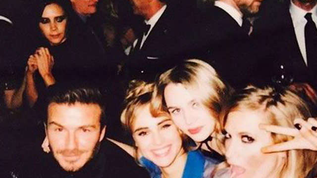 Victoria Beckham stares down Suki Waterhouse after she poses with David