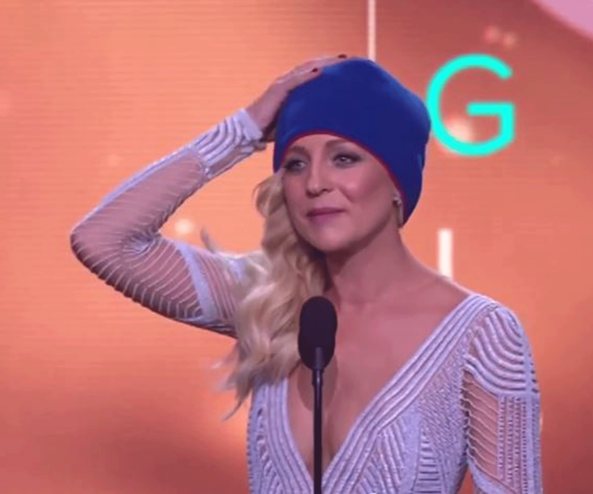 Golden girl! Carrie Bickmore accepts Logie in a beanie as a tribute to her late Husband