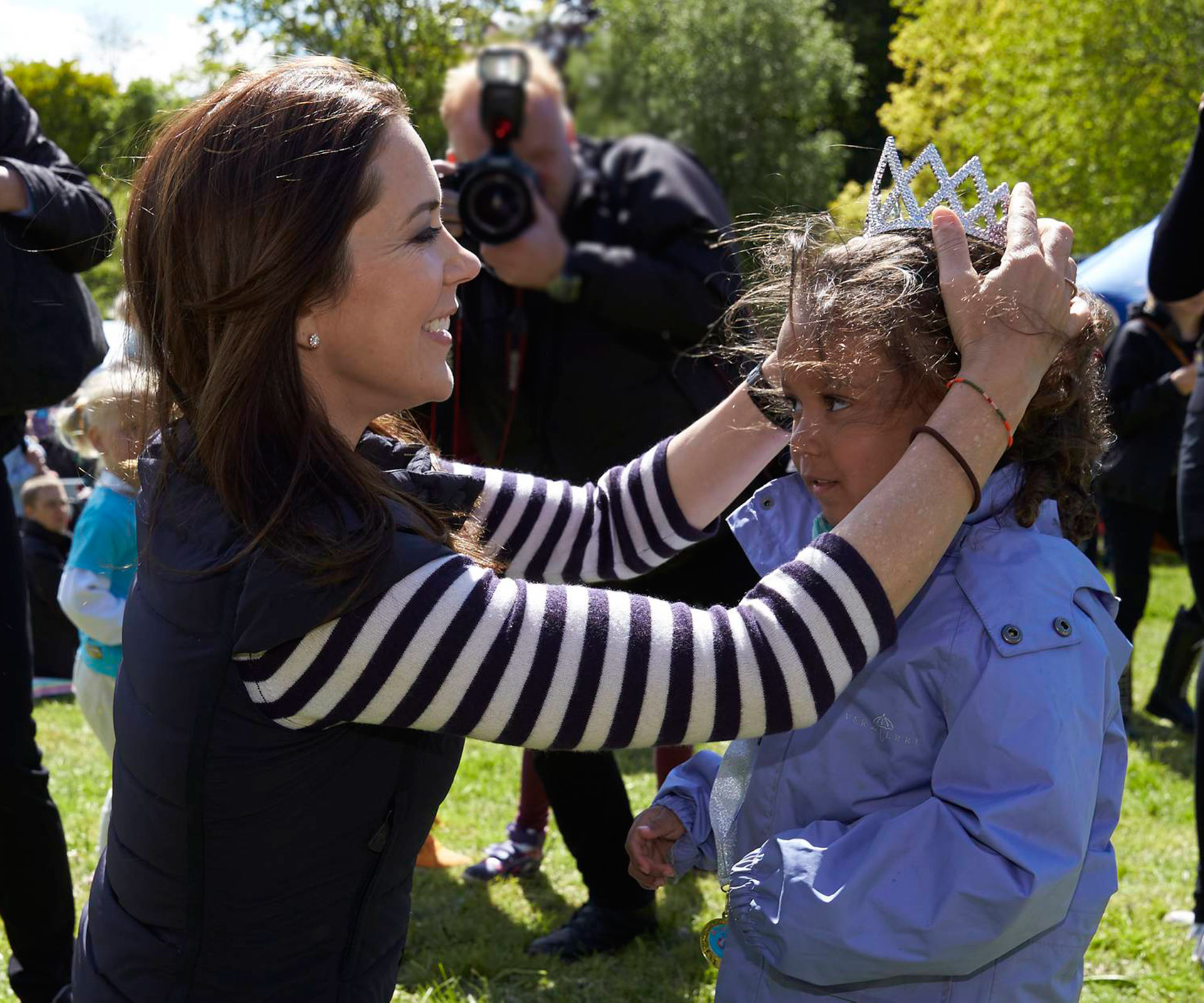 Princess Mary presents a little girl with a crown
